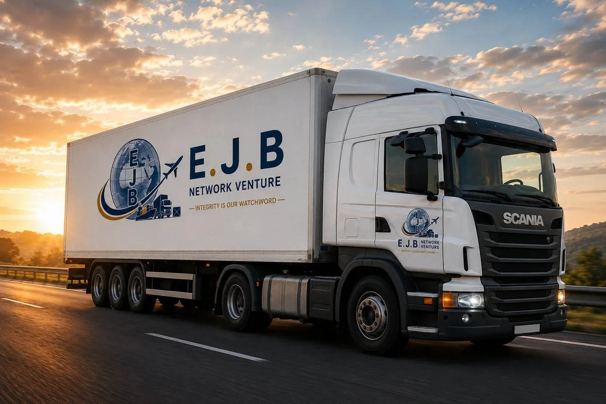 E.J.B branded freight truck on a highway at sunset